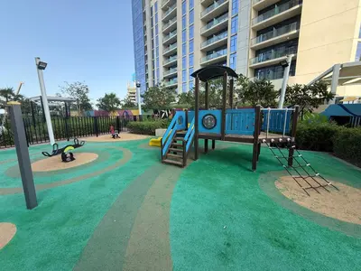 a playground with a slide in a park at New Cozy 1BR in the Heart of the City in Dubai