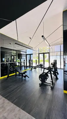 a gym with several treadmills and cardio machines at New Cozy 1BR in the Heart of the City in Dubai