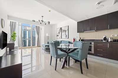 a kitchen and dining room with a table and chairs at Large 1 BR Duplex With Lake View in Dubai