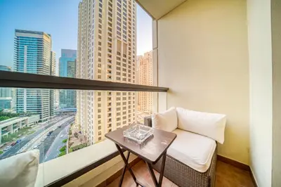 a room with a couch and a table and a window at Elite 1 BR in JBR with Marina Views in Dubai