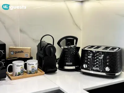 a counter with a toaster and coffee cups on it at HiGuests - Luxury Apt in the Heart of JVC at Binghatti Nova in Dubai