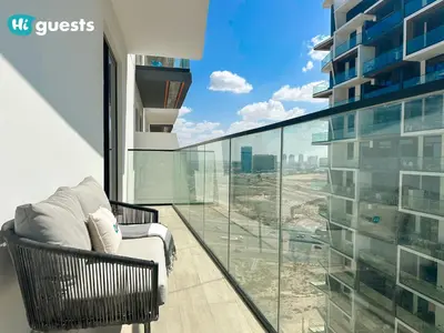 a balcony with a chair and a view of a city at HiGuests - Luxury Apt in the Heart of JVC at Binghatti Nova in Dubai