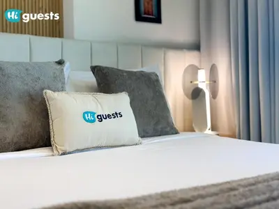 a bed with a pillow with a visa guest sign on it at HiGuests - Luxury Apt in the Heart of JVC at Binghatti Nova in Dubai
