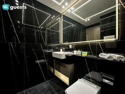a black bathroom with a sink and a toilet at HiGuests - Luxury Apt in the Heart of JVC at Binghatti Nova in Dubai