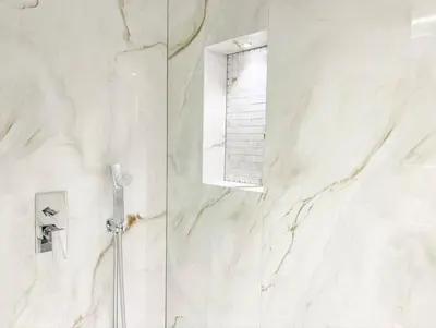 a white marble shower with a window in a bathroom at Luxury 4 Bed Apartment in Sadaf 8 on The Walk JBR in Dubai