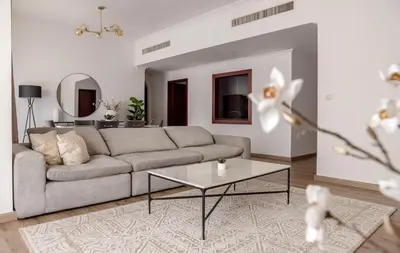 a living room with a couch and a table at Beautiful and bright 1 bedroom apartment! Sofia ! in Dubai