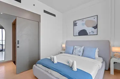 a bedroom with a bed with blue and white at Elegant Living in 1 BDR at JVC with Top Amenities in Dubai