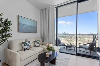 a living room with a couch and a table at Elegant Living in 1 BDR at JVC with Top Amenities in Dubai