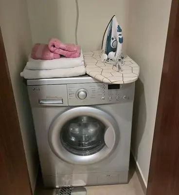 a washing machine with towels on top of it at Apartment in Business Bay, Dubai UAE in Dubai