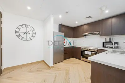 a kitchen with a large clock on the wall at Contemporary 1BR in Al Kifaf Residences West, Bur Dubai by Deluxe Holiday Homes in Dubai