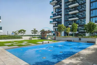 a swimming pool in front of a tall building at Contemporary 1BR in Al Kifaf Residences West, Bur Dubai by Deluxe Holiday Homes in Dubai