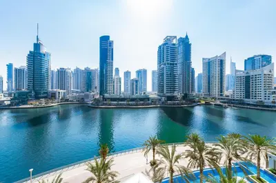 a river in a city with tall buildings at Chic 1BR Marina View Retreat in Dubai