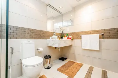a bathroom with a toilet and a mirror at Chic 1BR Marina View Retreat in Dubai