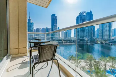 a balcony with a chair and a view of the city at Chic 1BR Marina View Retreat in Dubai