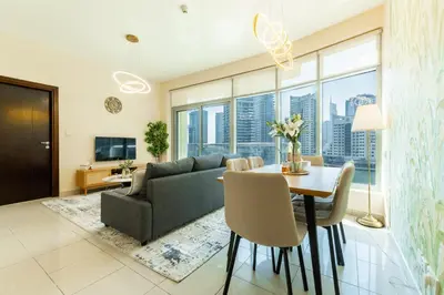 a living room with a couch and a table with chairs at Chic 1BR Marina View Retreat in Dubai