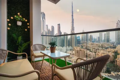 a balcony with a table and chairs and a view of a city at Bellevue Towers by Luxe Living - Full Burj Khalifa View in Dubai