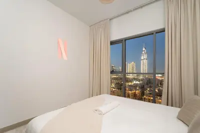 a bedroom with a large window with a city view at Bellevue Towers by Luxe Living - Full Burj Khalifa View in Dubai