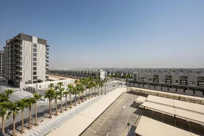 a view of a city with palm trees and buildings at Modern Meydan Studio Apartment - 15 min Drive to Downtown Dubai Mall in Dubai