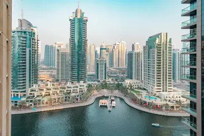 a view of a city with a river and buildings at Prime Retreats - steps to Grosvenor Hotel Marina in Dubai