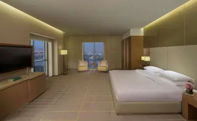a bedroom with a large bed and a flat screen tv at Hyatt Regency Dubai Creek Heights in Dubai