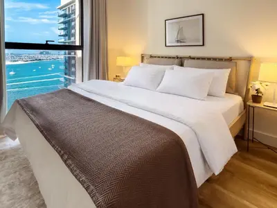 a bedroom with a large bed with a large window at Atlantis View 1BR with Beachfront Access and Balcony in Dubai