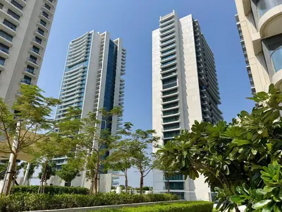 two tall buildings in a city with trees at Atlantis View 1BR with Beachfront Access and Balcony in Dubai
