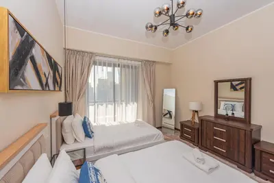 a bedroom with two beds and a window at Rimal 4, JBR- Elegant 2 BR in Dubai