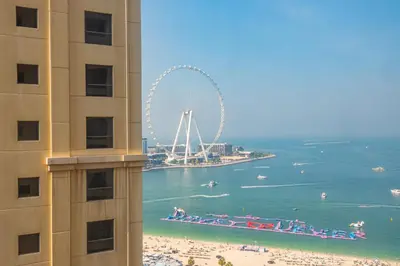 a view of the beach and the ferris wheel from a building at Rimal 4, JBR- Elegant 2 BR in Dubai