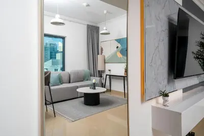 a living room with a couch and a table at Moderne 1BR with a lovely marina view in Dubai