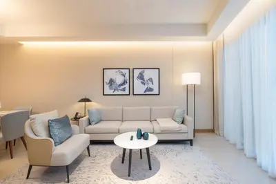 a living room with a couch and chairs and a table at Spacious 3 Bedroom Apartment in Downtown with Burj Khalifa view in Dubai