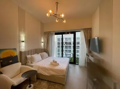 a bedroom with a bed with a teddy bear on it at Studio in Azizi Riviera 47 in Dubai