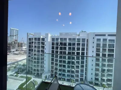 a view of a large building from a window at Studio in Azizi Riviera 47 in Dubai