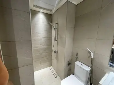 a bathroom with a shower and a toilet in it at Studio in Azizi Riviera 47 in Dubai