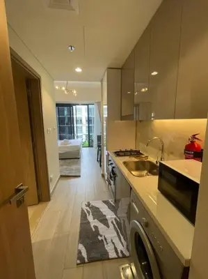 a kitchen with a sink and a dishwasher in it at Studio in Azizi Riviera 47 in Dubai