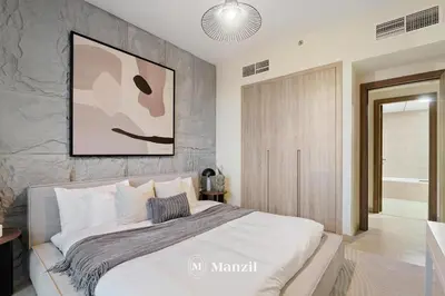 a bedroom with a large bed with a painting on the wall at Lux 2BR Apartment Near Dubai Mall & Burj Khalifa in Dubai
