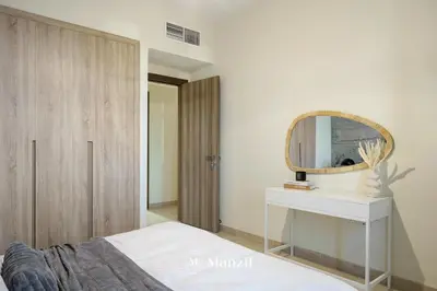 a bedroom with a dressing table and a mirror at Lux 2BR Apartment Near Dubai Mall & Burj Khalifa in Dubai