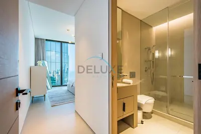 a bathroom with a shower and a toilet at Grand 3BR Aparment at The Address Residences in JBR by Deluxe Holiday Homes in Dubai