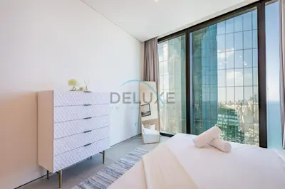 a bedroom with a bed and a large window at Grand 3BR Aparment at The Address Residences in JBR by Deluxe Holiday Homes in Dubai
