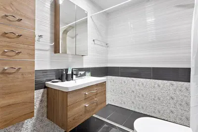 a bathroom with a sink and a toilet and a mirror at Modern Studio Close To Metro in Dubai