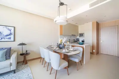 a kitchen and dining room with a table and chairs at Frank Porter - The Address Opera Residences in Dubai
