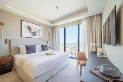 a hotel room with a bed and a large window at Frank Porter - The Address Opera Residences in Dubai