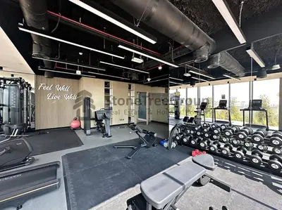 a gym with lots of treadmills and weights at Luxury Studio Near To Metro in Dubai