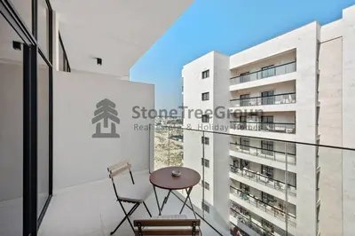a balcony with a table and chairs and a building at Luxury Studio Near To Metro in Dubai