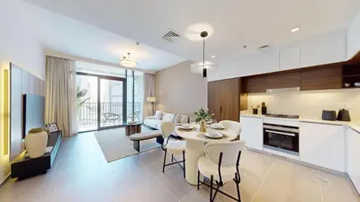 a kitchen and living room with a table and chairs at Creek Edge - Elegant One Bedroom in Creek Habour in Dubai