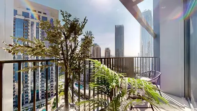 a balcony with plants and a view of a city at Creek Edge - One Bedroom with Partial Sea View in Dubai