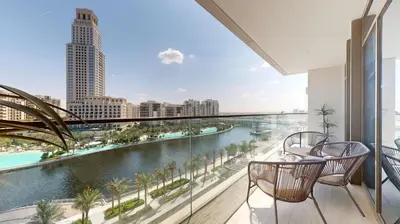 a balcony with a view of a river and buildings at Palace Residence - Chic Two Bed with Creek View in Dubai