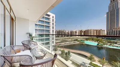 a balcony with chairs and a view of a city at Palace Residence - Chic Two Bed with Creek View in Dubai