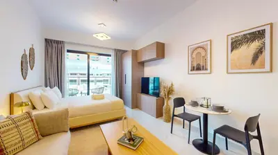 a hotel room with a bed and a table at Avanos Residence - Captivating Studio in JVC in Dubai