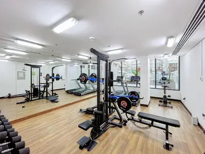 a gym with several treadmills and tread machines at Avanos Residence - Captivating Studio in JVC in Dubai