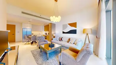 a living room with a couch and a table at Beach Vista 2 - Two Bedroom with Partial Sea View in Dubai